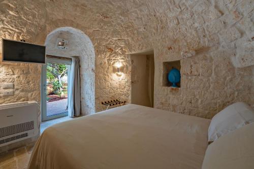 Ένα ή περισσότερα κρεβάτια σε δωμάτιο στο Trulli Capatosta