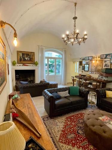 a living room with a couch and a table at Casina Colosso - relais&more - in Nardò