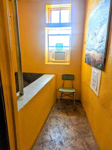 a chair in a small room with a window at Pelican Spa in Truth or Consequences