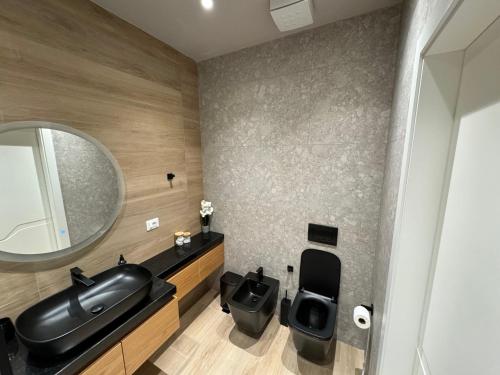 ヴロラにあるHeisol apartmentの洗面台と鏡のあるバスルーム