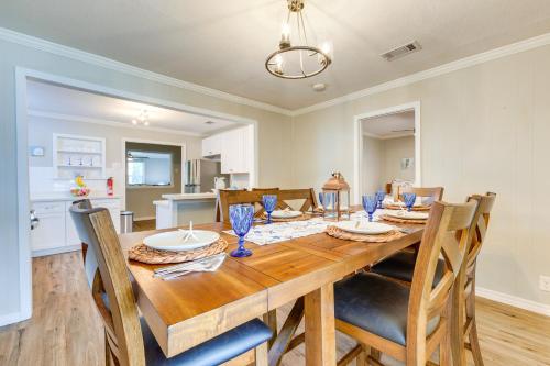 a dining room with a wooden table and chairs at Charming Gulfport Home about 2 Mi to Marina in Gulfport