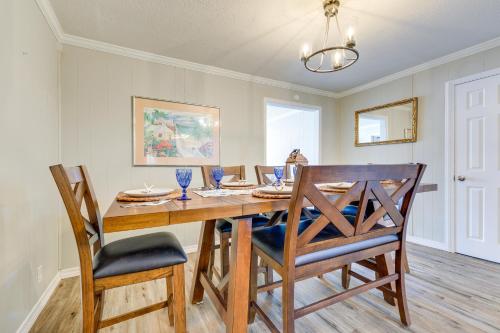 a dining room with a wooden table and chairs at Charming Gulfport Home about 2 Mi to Marina in Gulfport