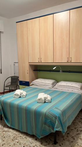 a bedroom with a bed with towels on it at Via Roma House in Terralba