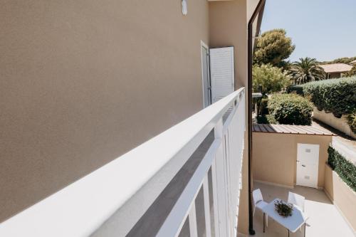 a balcony with a white railing and a bench at Casa Zefiro Fontane Bianche in Fontane Bianche