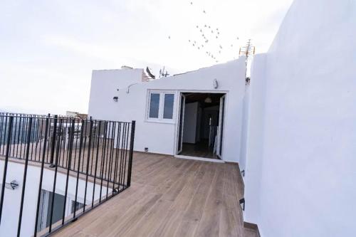 a balcony of a white house with a gate at Spacious house in Olvera with private pool in Olvera