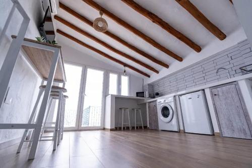 a laundry room with a staircase and a washing machine at Spacious house in Olvera with private pool in Olvera