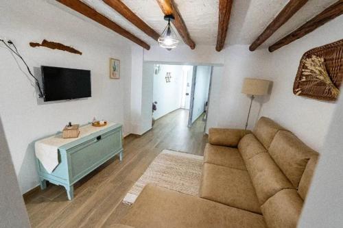 a living room with a couch and a tv at Spacious house in Olvera with private pool in Olvera
