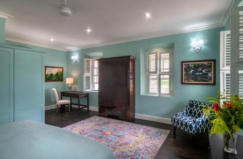 a living room with a couch and a table at Melrose House Dominica in Roseau