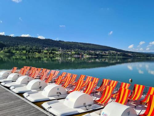 a row of beach chairs and umbrellas on a dock at Villa du Val d'Usiers in Bians-les-Usiers