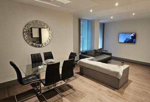 a living room with a table and a couch and a mirror at 8 Water Street in Liverpool