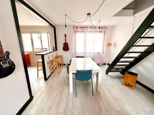 une salle à manger avec une table et un escalier dans l'établissement appartement Pickup, à Caen
