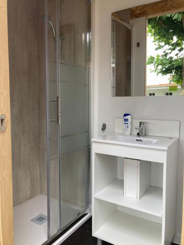 a bathroom with a glass shower and a sink at Camping Paxariñas in Portonovo
