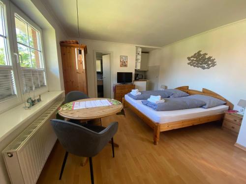 a bedroom with a bed and a table and a desk at Sylvie-Steinhardt-Wohnung-4 in List