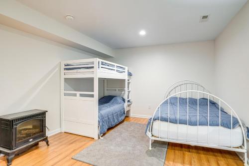 a bedroom with two bunk beds and a fireplace at Spacious Virginia Retreat with Dock and Beach Access! in Bumpass