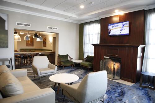 a waiting room with a fireplace and a tv at Fairfield Inn by Marriott Toronto Oakville in Oakville