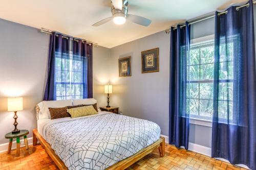 1 dormitorio con 1 cama y 2 ventanas con cortinas azules en Cozy Gainesville Home about 1 Mi to University!, en Gainesville