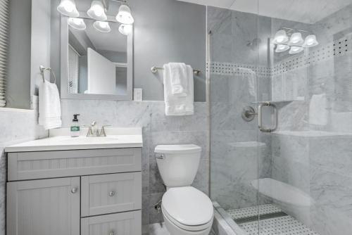 a bathroom with a shower and a toilet and a sink at Modern Twist In A Historic Building, Sleeps 6 in Atlanta