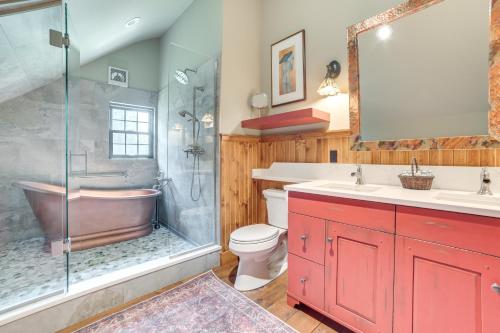 a bathroom with a tub and a toilet and a shower at Peaceful Farmhouse with Fire Pit Near Town and Lake! in Harbor Springs