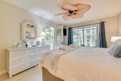 a bedroom with a large bed with a ceiling fan at Private Deck & Pool Access: Myrtle Beach Getaway! in Myrtle Beach