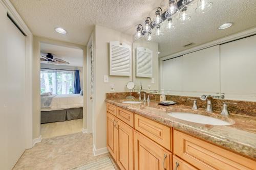 a bathroom with two sinks and a large mirror at Private Deck & Pool Access: Myrtle Beach Getaway! in Myrtle Beach