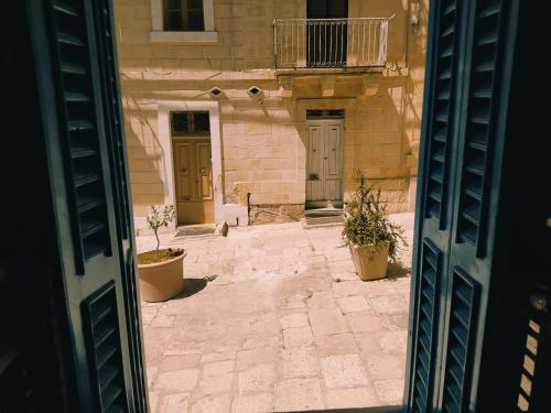 an entrance to a building with two doors and potted plants at 3 Cities Heart 2 in Cospicua