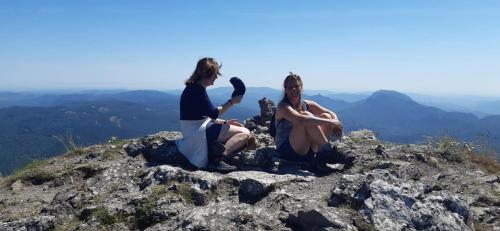 two women sitting on the top of a mountain at Gîte de la Bastide - Cabania Pays Cathare in Camps-sur-lʼAgly