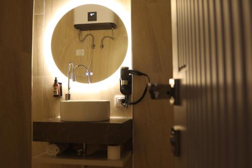 a bathroom with a sink and a mirror at Anchor Luxury Rooms in Vlorë