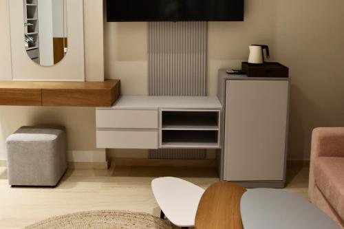 a living room with a white cabinet and a mirror at Anchor Luxury Rooms in Vlorë