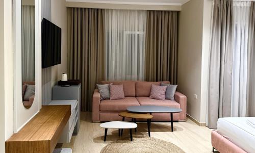 a living room with a couch and a table at Anchor Luxury Rooms in Vlorë