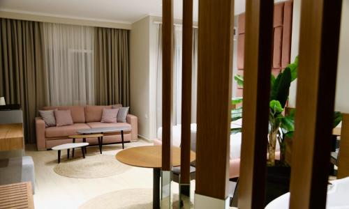 a living room with a couch and a table at Anchor Luxury Rooms in Vlorë