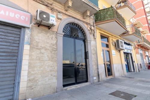 a building with a glass door on a street at La Dimora dei Nipoti in Bari