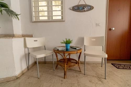 two chairs and a small table with a plant on it at La Dimora dei Nipoti in Bari