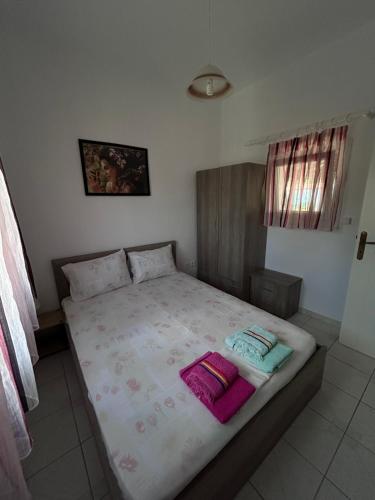 a bedroom with a bed with two pillows on it at Studio Metamorfosi in Metamorfosi