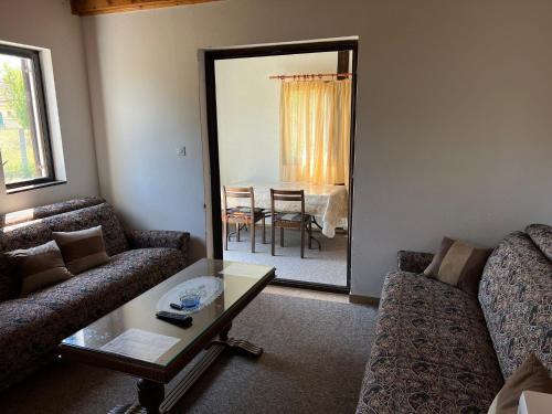 a living room with two couches and a mirror at Weekend house & apartments Dubrave in Visoko