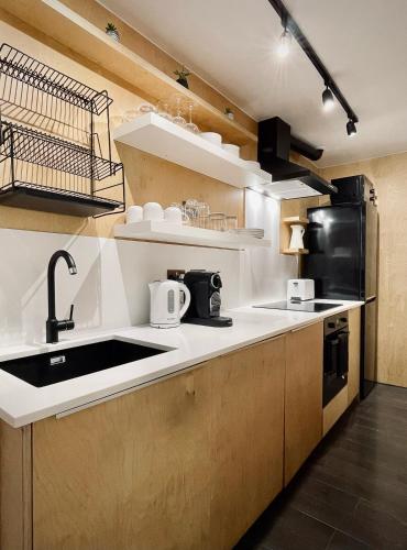 a kitchen with a sink and a counter top at Spacious Two Bedroom Apartment in the Heart of Notting Hill in London