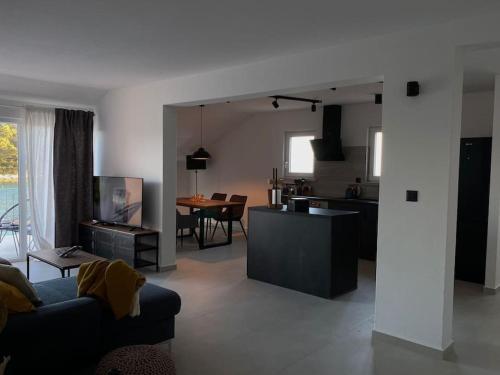 a living room and kitchen with a couch and a table at La Familia in Blato
