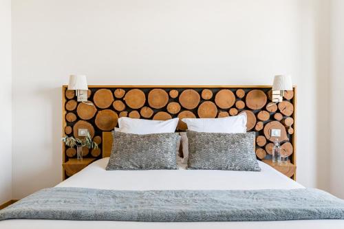 a bedroom with a bed with a large wooden headboard at Villa Elisa M in Aubenas