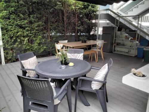 a patio with a table and chairs on a deck at Buddies Charm Apt - Self Catering in Aveiro