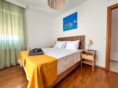 a bedroom with a bed with a yellow blanket on it at Sea Breeze III Apartment in Perea