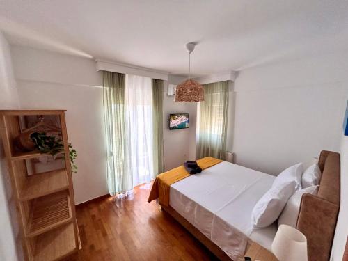 a bedroom with a white bed and a couch at Sea Breeze III Apartment in Perea