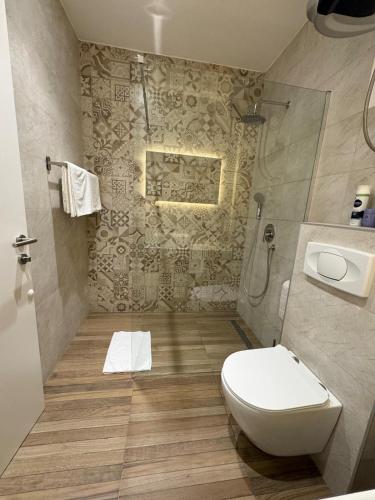 a bathroom with a toilet and a sink at Apartments ABC in Mostar