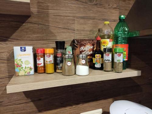 a shelf with various spices and bottles on it at Bungalow mit Terrasse und Spielplatz in Ostseenähe in Wobbelkow