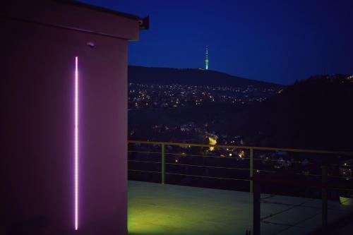 a view of a city from a balcony at night at Villa46 in Pécs