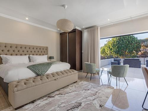 a bedroom with a large bed and a large window at Self Checkin - Luxury Tranquil Apartment in Guesthouse in Johannesburg