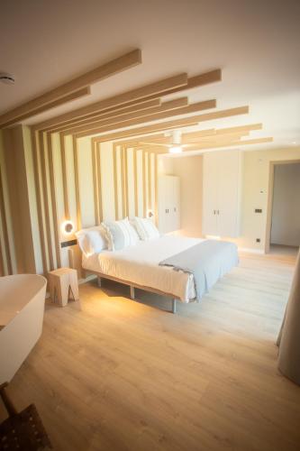 a bedroom with a large bed in a room at L'indret del Pedraforca Adults Only in Saldés