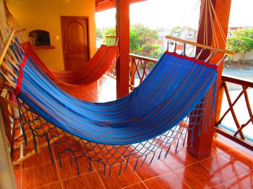 a hammock on a porch with at Hotel Mediterraneo in Canoa