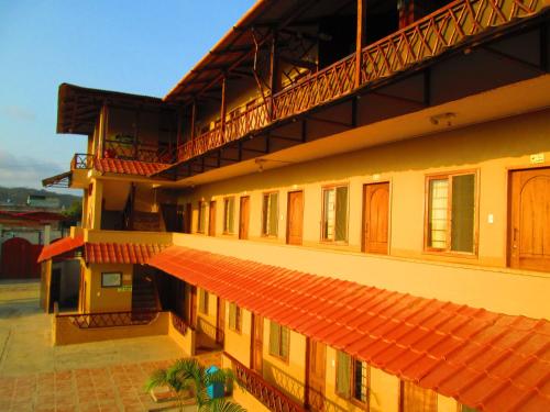 a building with a red roof and a building at Hotel Mediterraneo in Canoa