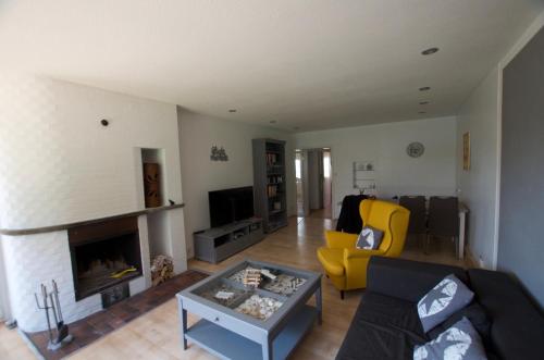 a living room with a couch and a fireplace at "Tag am Meer" - Residenz Glücksmomente EG in Langeoog
