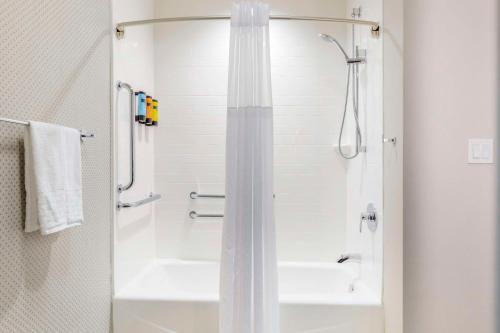 a bathroom with a shower with a shower curtain at GLō Best Western Dallas South DeSoto in DeSoto