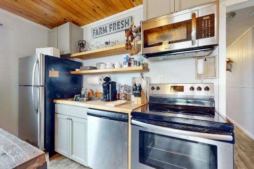 a kitchen with stainless steel appliances and wooden ceilings at Pinnacle Inn #3302 in Beech Mountain